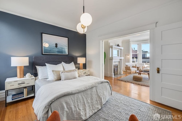 813 Union St, San Francisco, CA 94133 - bedroom with wood finished floors, crown molding, and a fireplace