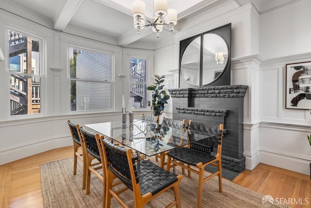 813 Union St, San Francisco, CA 94133 - dining area featuring a chandelier, beam ceiling, crown molding, light wood-style flooring, and coffered ceiling
