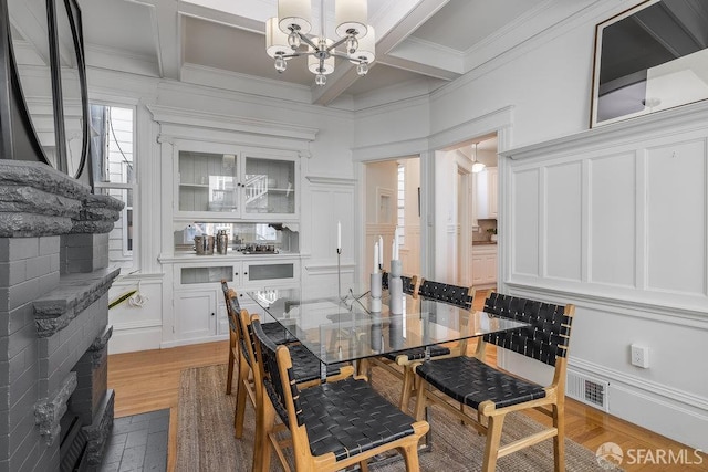813 Union St, San Francisco, CA 94133 - dining area featuring a decorative wall, a chandelier, coffered ceiling, crown molding, and beamed ceiling