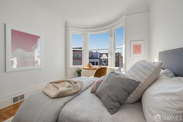 813 Union St, San Francisco, CA 94133 - bedroom featuring multiple windows, ornamental molding, and wood finished floors