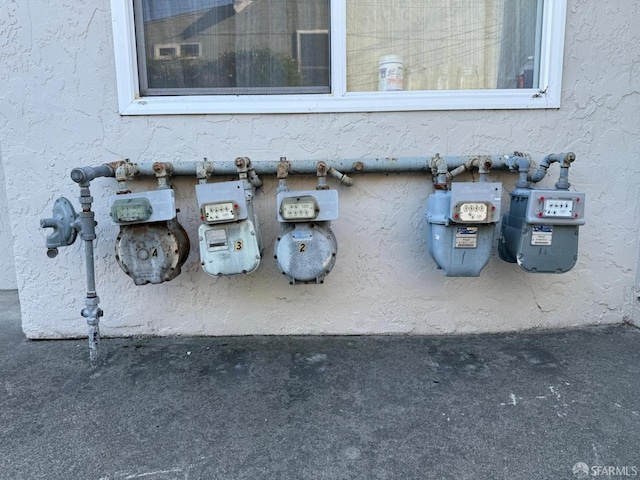 details featuring gas meter and stucco siding