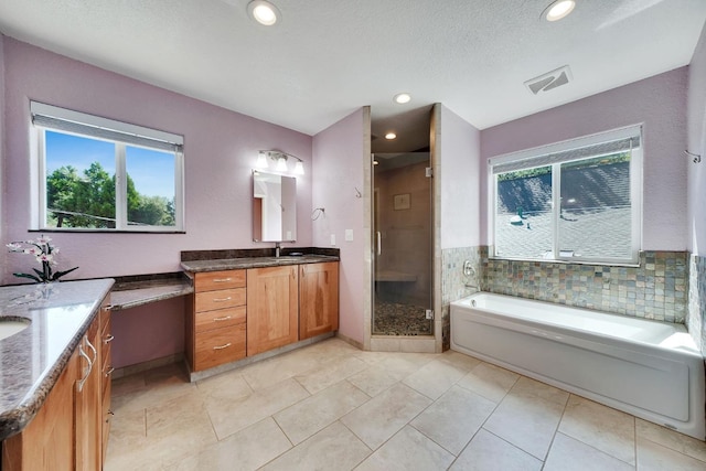 full bathroom featuring a shower stall, vanity, visible vents, and plenty of natural light