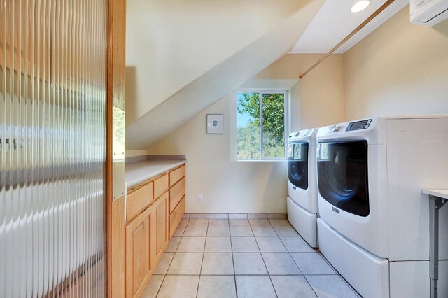 washroom with washing machine and dryer, light tile patterned flooring, baseboards, cabinet space, and a wall mounted AC