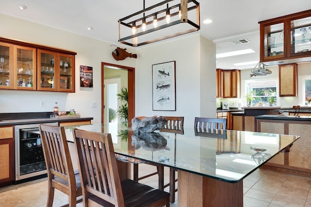 dining space featuring a bar, beverage cooler, light tile patterned floors, visible vents, and recessed lighting