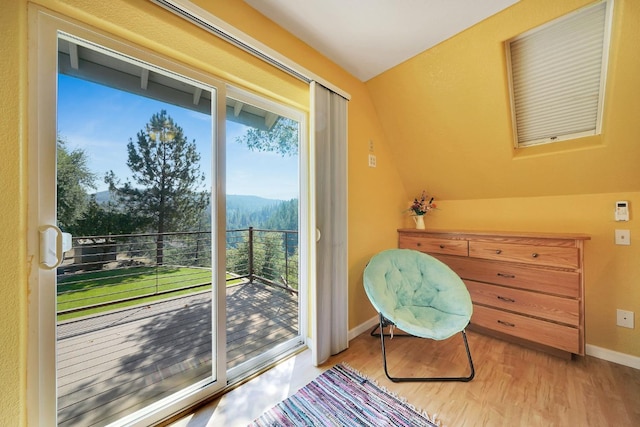 sitting room featuring wood finished floors, baseboards, and a mountain view