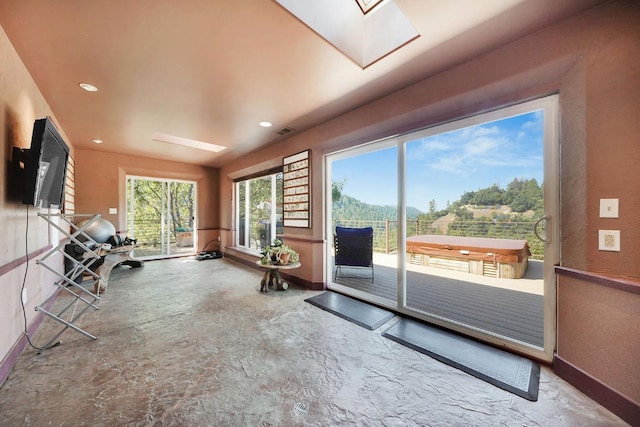 interior space with a skylight, baseboards, recessed lighting, and visible vents