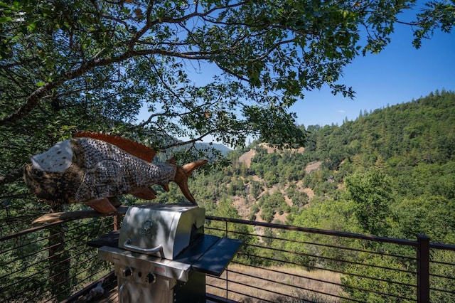 exterior space with grilling area and a forest view