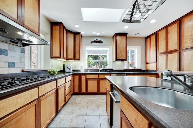 kitchen with extractor fan, a skylight, a sink, and black gas cooktop