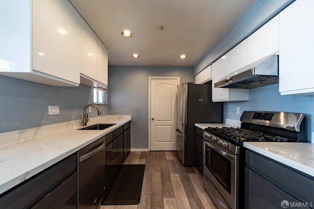 981 Asilomar Ter Unit 1, Sunnyvale, CA 94086 - kitchen with appliances with stainless steel finishes, under cabinet range hood, white cabinets, modern cabinets, and recessed lighting