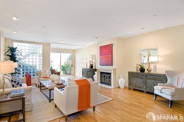 2040 Broadway St Unit 102, San Francisco, CA 94115 - living area featuring light wood-style floors, a glass covered fireplace, and recessed lighting