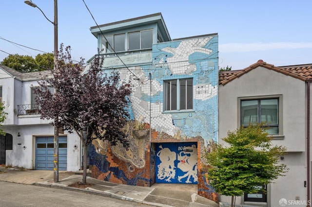 80 Bronte St, San Francisco, CA 94110 - view of front of house with a garage and stucco siding