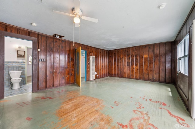 80 Bronte St, San Francisco, CA 94110 - unfurnished living room featuring ceiling fan and wood walls