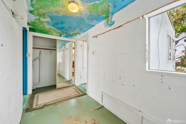 80 Bronte St, San Francisco, CA 94110 - unfurnished bedroom with finished concrete floors, multiple windows, and a closet