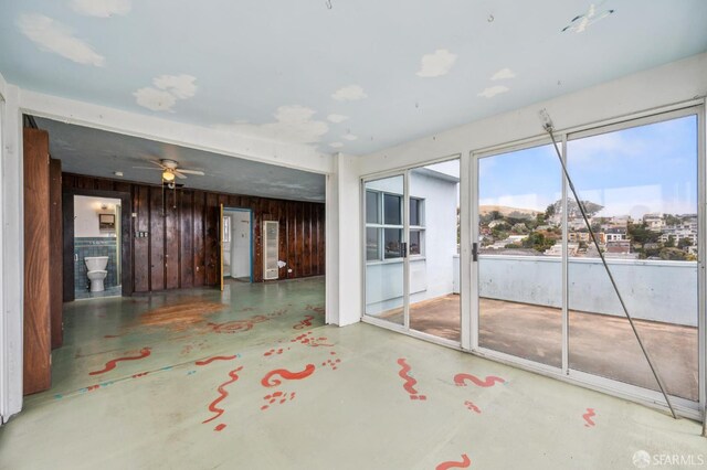 80 Bronte St, San Francisco, CA 94110 - empty room featuring concrete flooring, a ceiling fan, and wooden walls