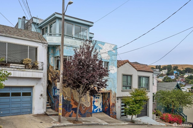 80 Bronte St, San Francisco, CA 94110 - view of front of property with stucco siding, a garage, and driveway