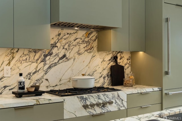 interior details with high quality fridge, green cabinets, and tasteful backsplash