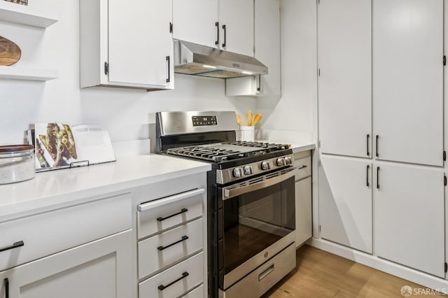 1520 Taylor St Unit 103, San Francisco, CA 94133 - kitchen with stainless steel range with gas cooktop, under cabinet range hood, open shelves, light countertops, and white cabinets