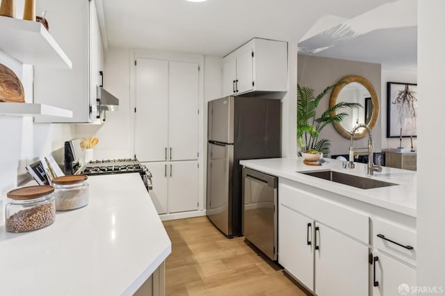 1520 Taylor St Unit 103, San Francisco, CA 94133 - kitchen with appliances with stainless steel finishes, wall chimney range hood, light countertops, and light wood-style floors
