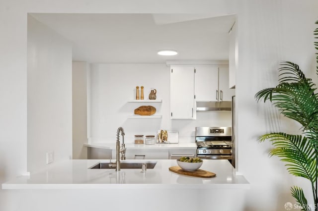 1520 Taylor St Unit 103, San Francisco, CA 94133 - kitchen featuring gas range, under cabinet range hood, open shelves, white cabinets, and light countertops