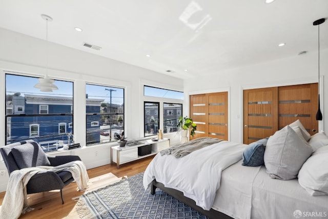 bedroom featuring recessed lighting, visible vents, and wood finished floors