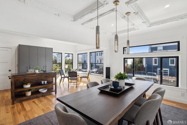 dining area with a high ceiling and light wood-type flooring