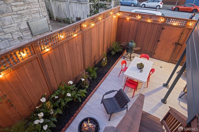 view of patio / terrace featuring a wooden deck and fence