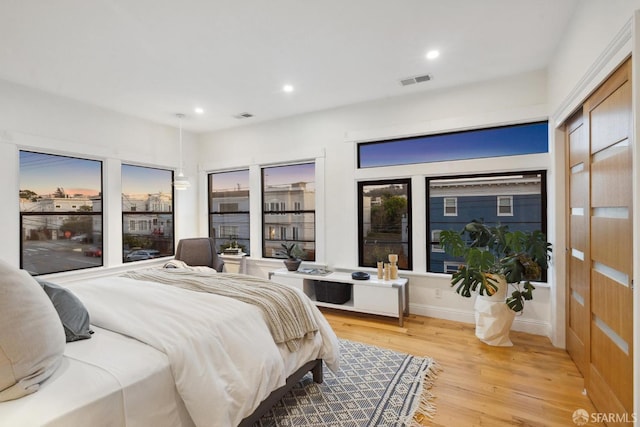 bedroom featuring recessed lighting, visible vents, and light wood finished floors