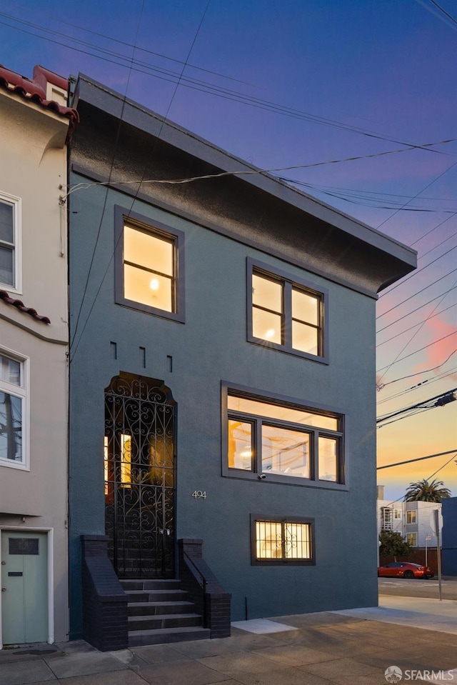 view of front of home featuring stucco siding and entry steps