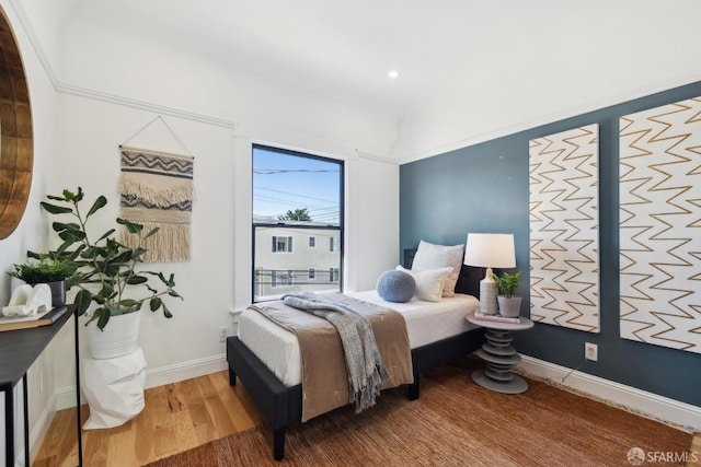 bedroom featuring baseboards and wood finished floors