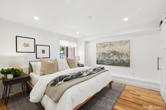 bedroom featuring recessed lighting, baseboards, and wood finished floors