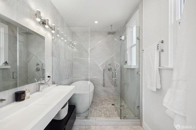 bathroom with a soaking tub, a stall shower, and vanity