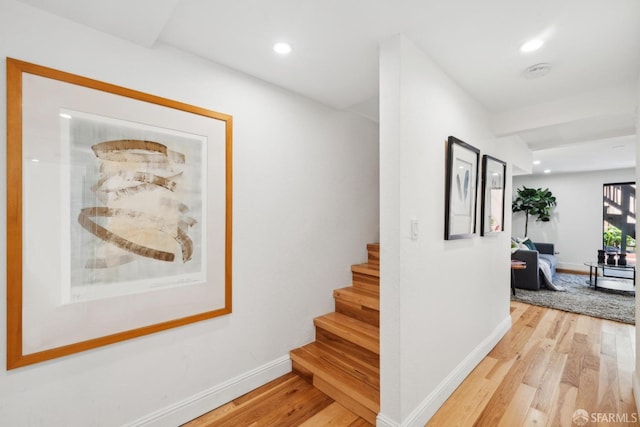 hall with stairway, recessed lighting, light wood-style floors, and baseboards