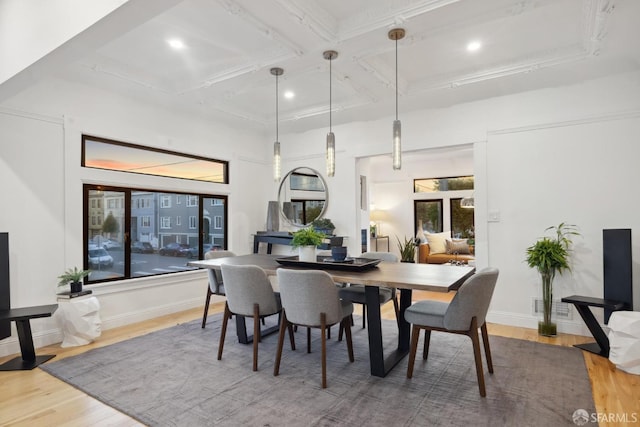 dining room featuring visible vents, baseboards, coffered ceiling, and wood finished floors