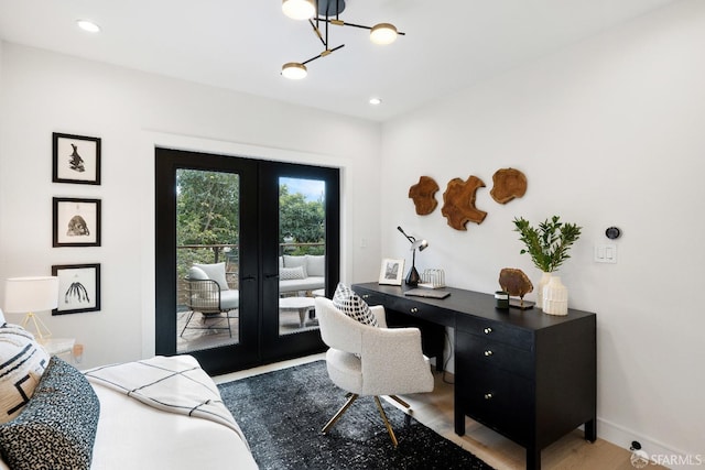 office space with light hardwood / wood-style floors and french doors