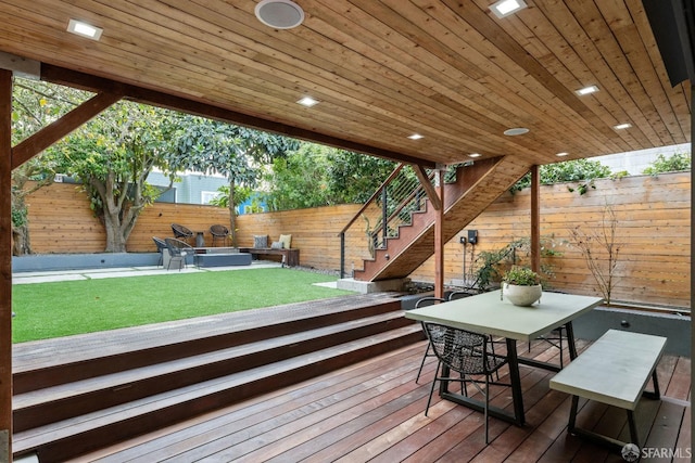 wooden deck with a hot tub