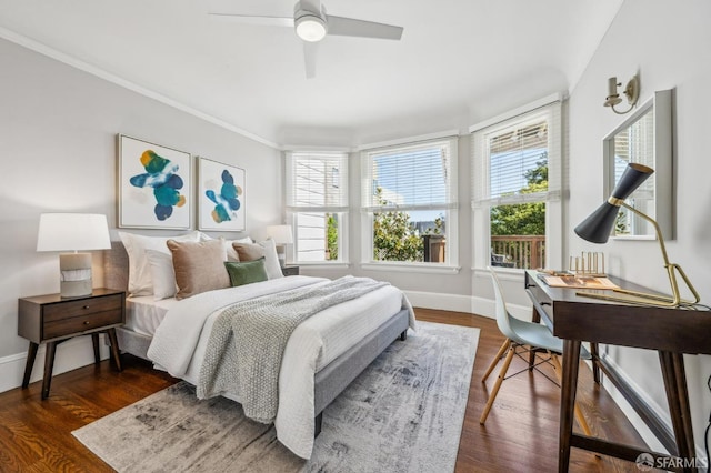 bedroom with baseboards, ceiling fan, ornamental molding, and wood finished floors