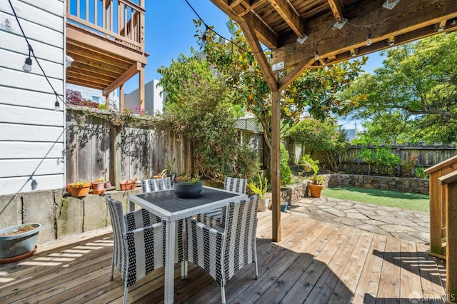 deck featuring outdoor dining area and a fenced backyard
