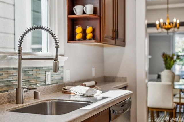 kitchen with open shelves, light stone counters, dishwasher, a chandelier, and tasteful backsplash