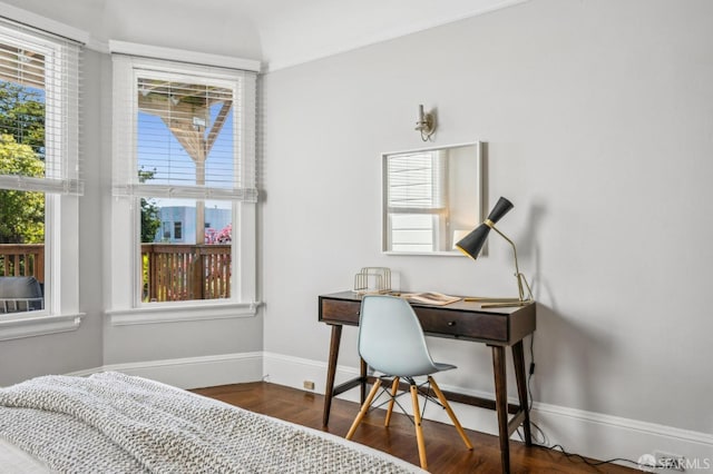 bedroom featuring baseboards and wood finished floors