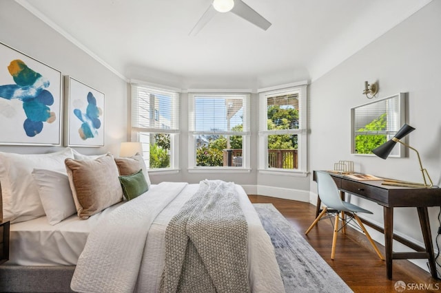 bedroom with baseboards, a ceiling fan, and dark wood-style flooring