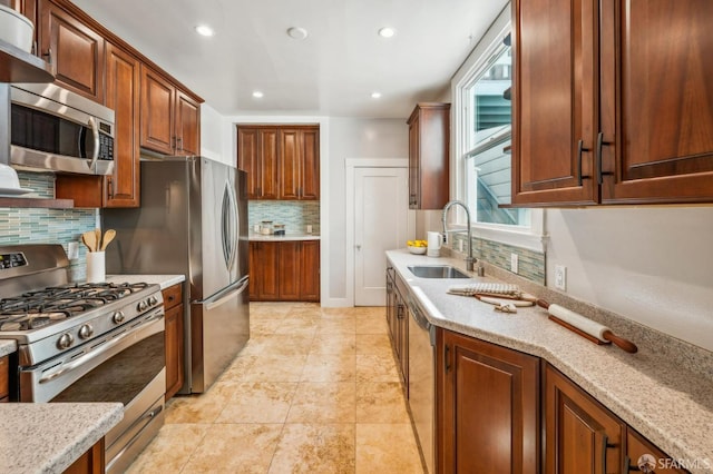 kitchen with recessed lighting, a sink, appliances with stainless steel finishes, and backsplash