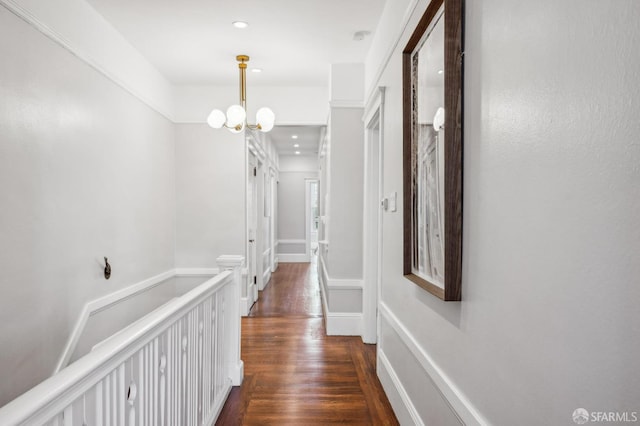 corridor featuring recessed lighting, dark wood finished floors, and a chandelier