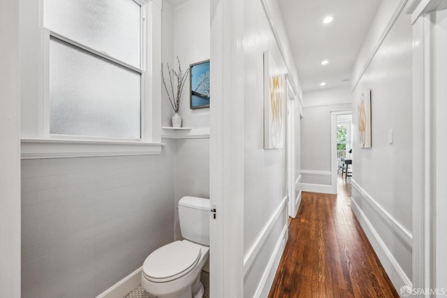 bathroom featuring recessed lighting, baseboards, toilet, and wood finished floors