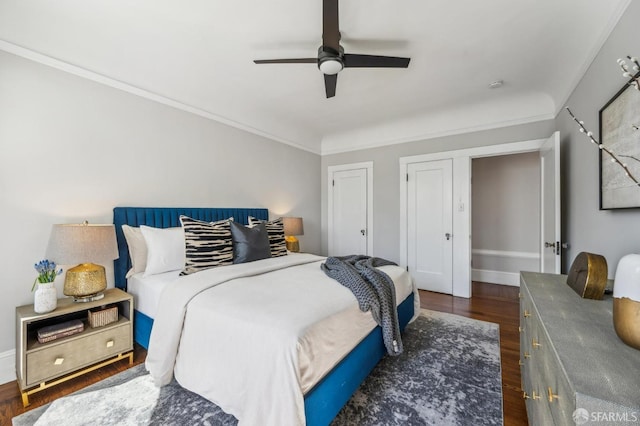 bedroom featuring baseboards, ceiling fan, ornamental molding, and dark wood-style flooring