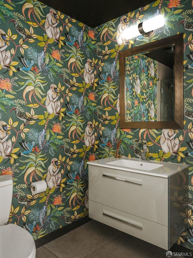 bathroom featuring vanity, toilet, and tile patterned floors