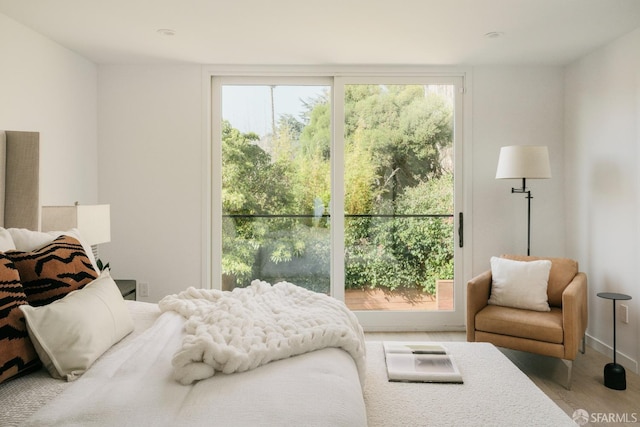 bedroom with wood-type flooring and multiple windows