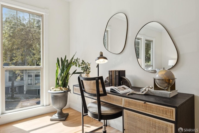 office space with baseboards and wood finished floors