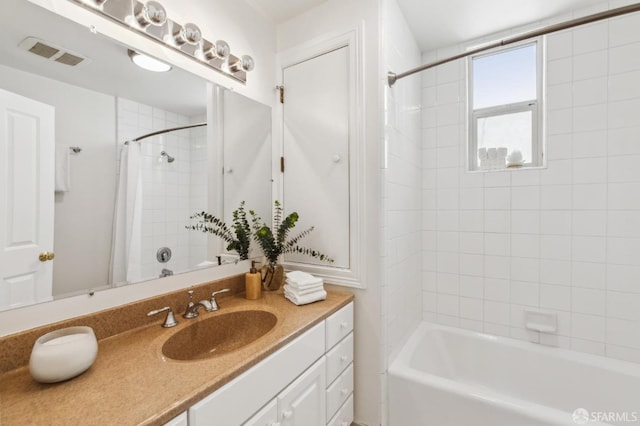 full bath featuring visible vents, shower / bath combination with curtain, and vanity