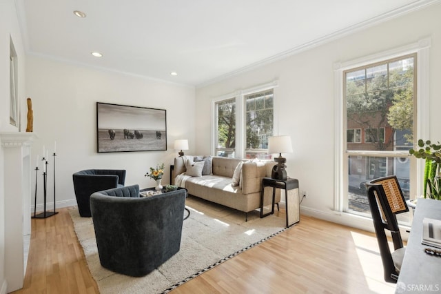 living area featuring crown molding, recessed lighting, and light wood-style floors