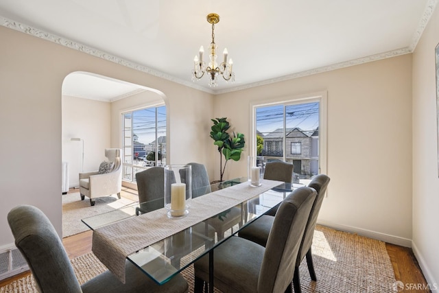 1874 34th Ave, San Francisco, CA 94122 - dining room with arched walkways, crown molding, a chandelier, and wood finished floors